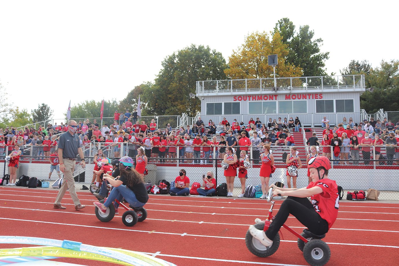 Students of all grades participate in a tricycle relay race at Southmont. Racers had to exchange helmets, eat several marshmallows and chug a pop during each leg of the race.